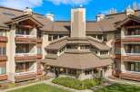 Experience the charm of this multi-story building featuring a unique, multi-faceted roofline and prominent chimneys.