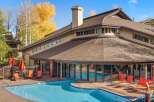 Enjoy a refreshing dip in the sparkling blue pool, surrounded by a beautifully paved patio and comfortable lounge chairs.