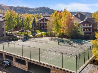 Enjoy outdoor recreation with this stunning tennis court, perfect for a friendly match or practice.