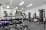 This well-equipped home gym features a variety of cardio machines including treadmills and ellipticals, perfect for your daily workout routine.