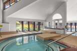 Indulge in relaxation in this indoor spa, featuring a spacious hot tub with built-in seating and a soothing ambiance.