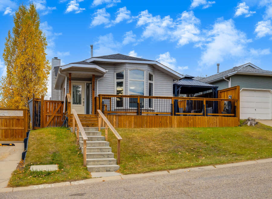 This charming home features a spacious wooden deck perfect for outdoor entertaining, complete with a covered gazebo for all-weather enjoyment.