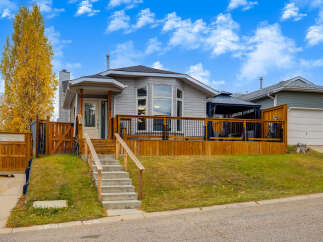 This charming home features a spacious wooden deck perfect for outdoor entertaining, complete with a covered gazebo for all-weather enjoyment.