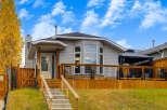 This charming home features a spacious wooden deck perfect for outdoor entertaining, complete with a covered gazebo.