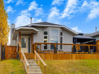 This charming home features a spacious wooden deck perfect for outdoor entertaining, complete with a covered gazebo.