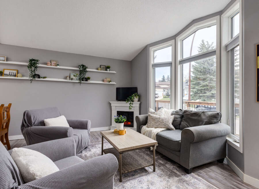 Step into this inviting living room, bathed in natural light from the large bay windows.