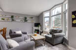 Step into this inviting living room, bathed in natural light from the large bay windows.