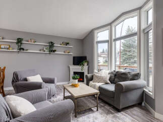 Step into this inviting living room, bathed in natural light from the large bay windows.