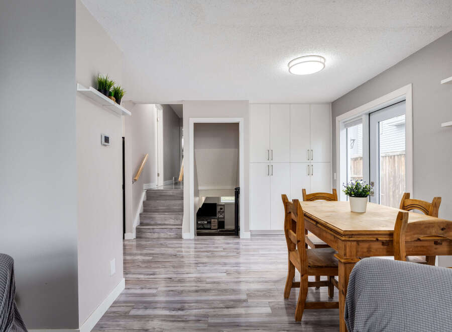 This inviting dining area features a rustic wooden table and chairs, perfect for family meals.