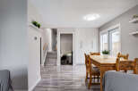 This inviting dining area features a rustic wooden table and chairs, perfect for family meals.
