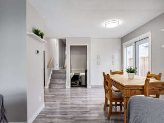 This inviting dining area features a rustic wooden table and chairs, perfect for family meals.