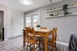 This dining area features a rustic wooden table with four chairs, perfect for intimate family meals.
