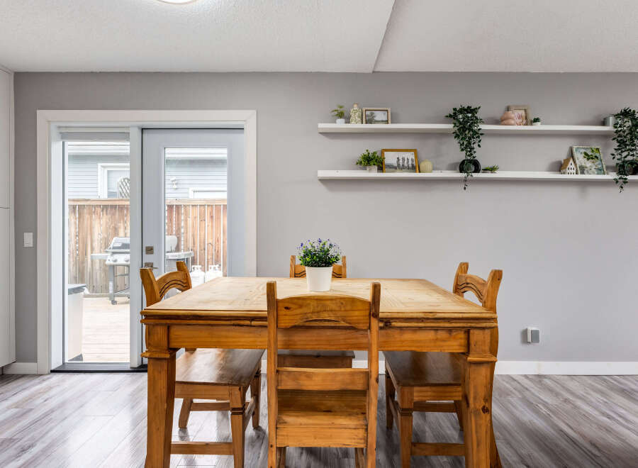 Enjoy meals with family and friends in this charming dining area, featuring a rustic wooden table and chairs.