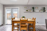 Enjoy meals with family and friends in this charming dining area, featuring a rustic wooden table and chairs.