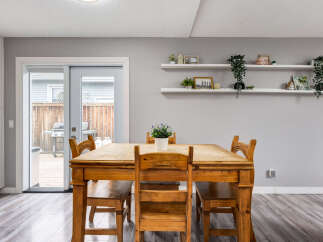 Enjoy meals with family and friends in this charming dining area, featuring a rustic wooden table and chairs.