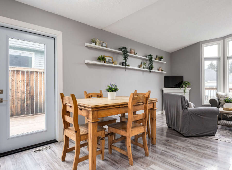 This inviting dining area features a charming wooden table with four chairs, perfect for family meals.