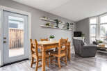 This inviting dining area features a charming wooden table with four chairs, perfect for family meals.