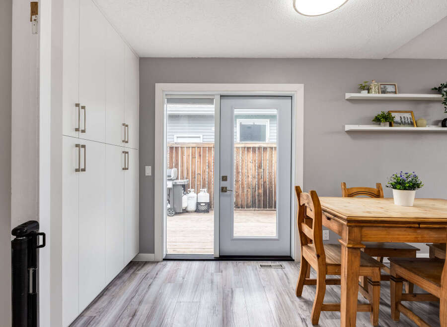 This dining area features a light wood table with matching chairs, perfect for family meals.