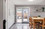This dining area features a light wood table with matching chairs, perfect for family meals.