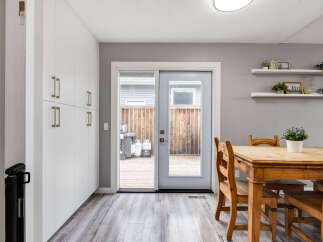 This dining area features a light wood table with matching chairs, perfect for family meals.