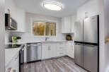 Step into this beautifully updated kitchen, featuring sleek stainless steel appliances including a French door refrigerator and a modern microwave.