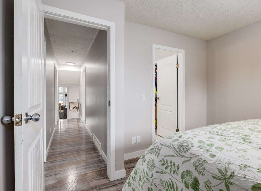 Step into a bright and airy hallway leading to multiple rooms, perfect for a growing family or hosting guests.