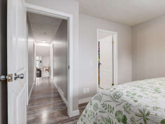 Step into a bright and airy hallway leading to multiple rooms, perfect for a growing family or hosting guests.