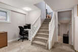 Discover a functional basement space featuring a dedicated home office area with a desk and chair, perfect for remote work or study.