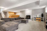 This spacious basement living area features a large, comfortable sectional sofa perfect for family gatherings.