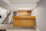 Step into this inviting basement featuring a spacious bar area perfect for entertaining.