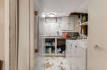 This basement laundry room features a white Maytag washer and dryer, perfect for handling your household chores.