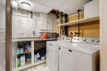 This laundry room features a Maytag washer and dryer set, perfect for handling your household chores.