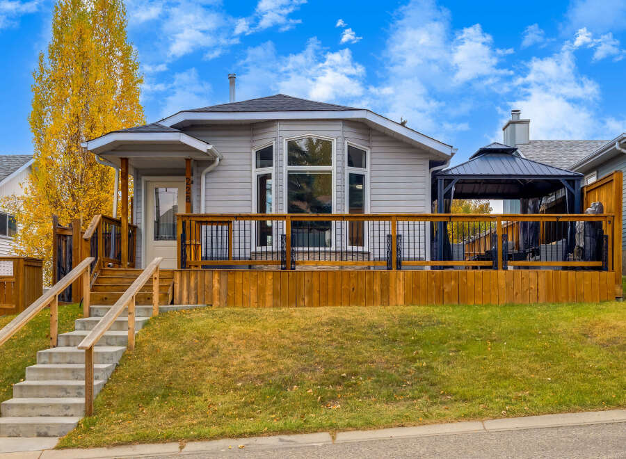 This charming home features a spacious wooden deck perfect for outdoor entertaining, complete with a covered gazebo.