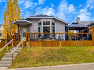 This charming home features a spacious wooden deck perfect for outdoor entertaining, complete with a covered gazebo.