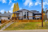 This charming home features a spacious wooden deck perfect for outdoor entertaining, complete with a covered gazebo area.