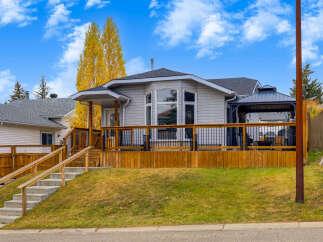 This charming home features a spacious wooden deck perfect for outdoor entertaining, complete with a covered gazebo area.