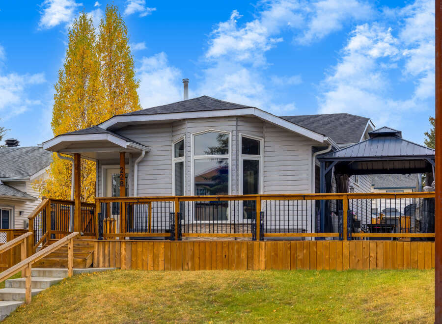 This charming home features a spacious wooden deck perfect for outdoor entertaining, complete with a covered gazebo.