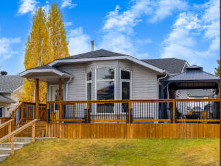 This charming home features a spacious wooden deck perfect for outdoor entertaining, complete with a covered gazebo.