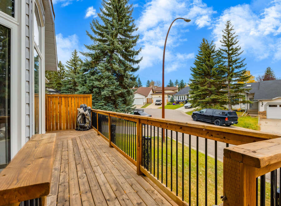 Enjoy outdoor living on this spacious wooden deck, perfect for entertaining or relaxing.