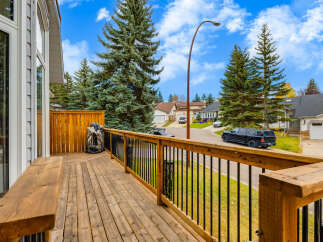 Enjoy outdoor living on this spacious wooden deck, perfect for entertaining or relaxing.