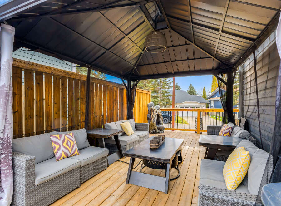 Enjoy outdoor living in this spacious covered patio, perfect for entertaining or relaxing.