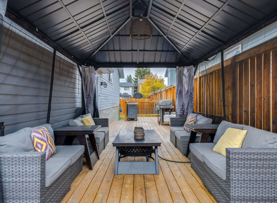 Enjoy outdoor living in this covered patio, perfect for entertaining or relaxing.