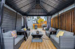 Enjoy outdoor living in this covered patio, perfect for entertaining or relaxing.