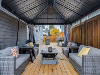 Enjoy outdoor living in this covered patio, perfect for entertaining or relaxing.