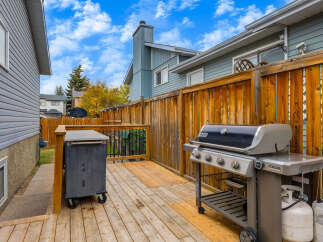 Enjoy outdoor living on this spacious wooden deck, perfect for entertaining.