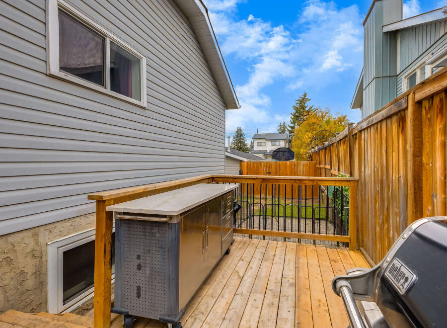 Enjoy outdoor living on this spacious wooden deck, perfect for entertaining guests.
