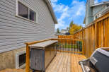 Enjoy outdoor living on this spacious wooden deck, perfect for entertaining guests.