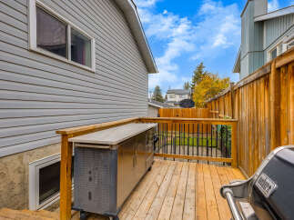 Enjoy outdoor living on this spacious wooden deck, perfect for entertaining guests.