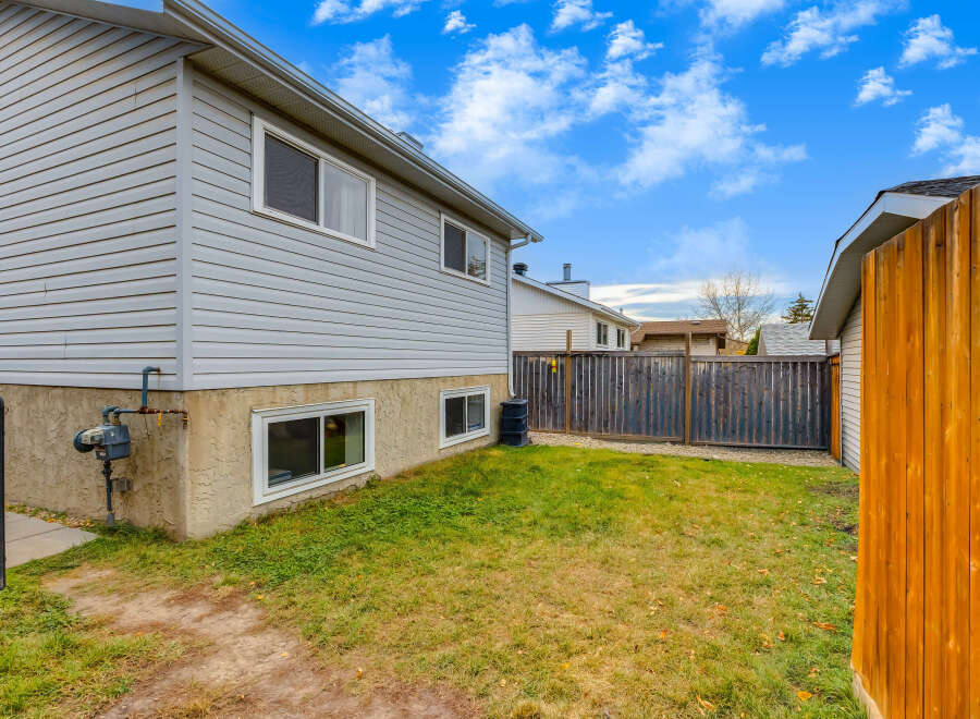 Discover this charming home featuring a well-maintained exterior with light gray vinyl siding and a stucco-finished foundation.