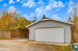 This property features a detached garage with a classic white sectional door, perfect for protecting your vehicles.